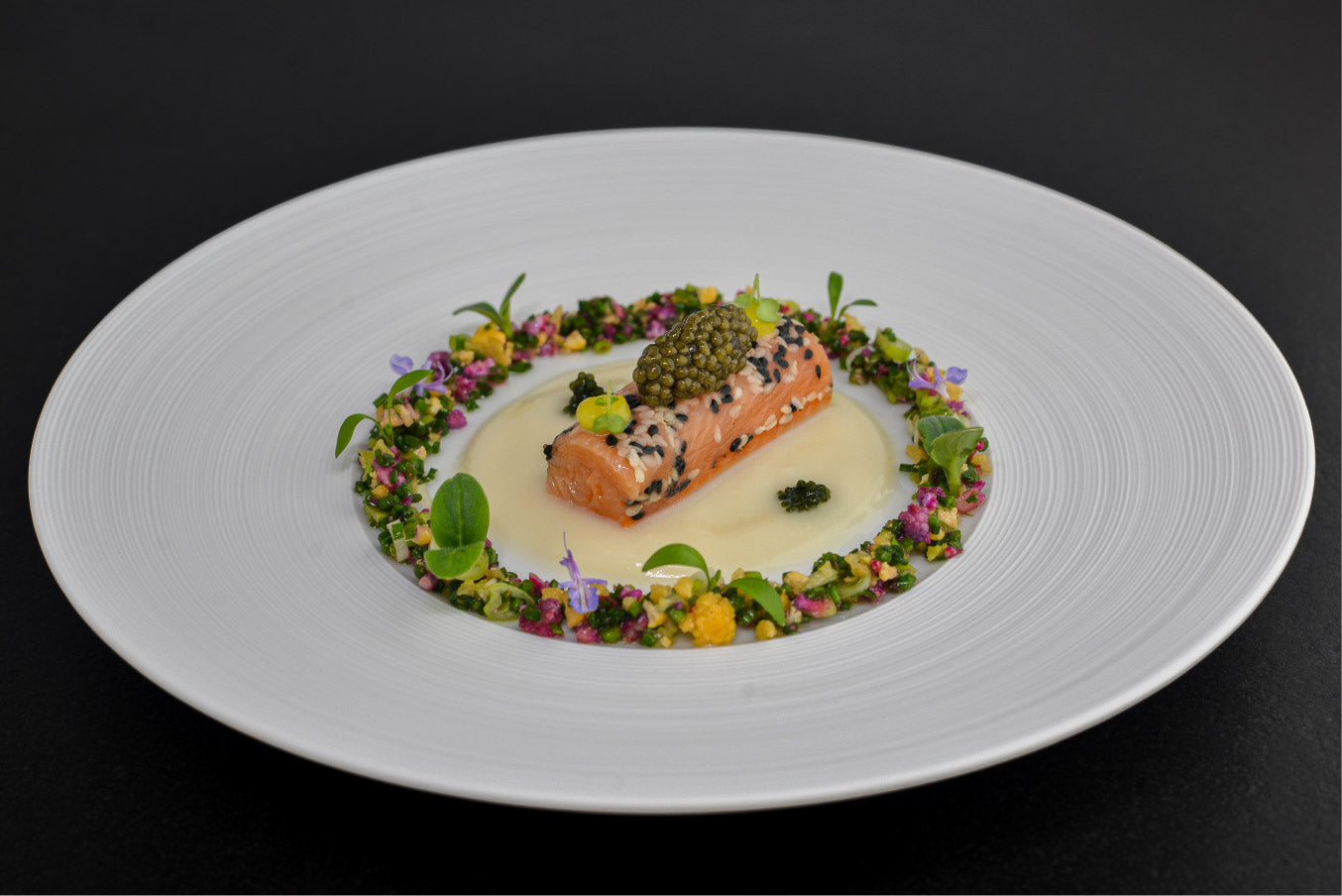 Image d'un plat raffiné d'omble chevalier avec du chou-fleur fumé et du caviar oscietre